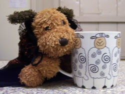 amber dog with mug of tea